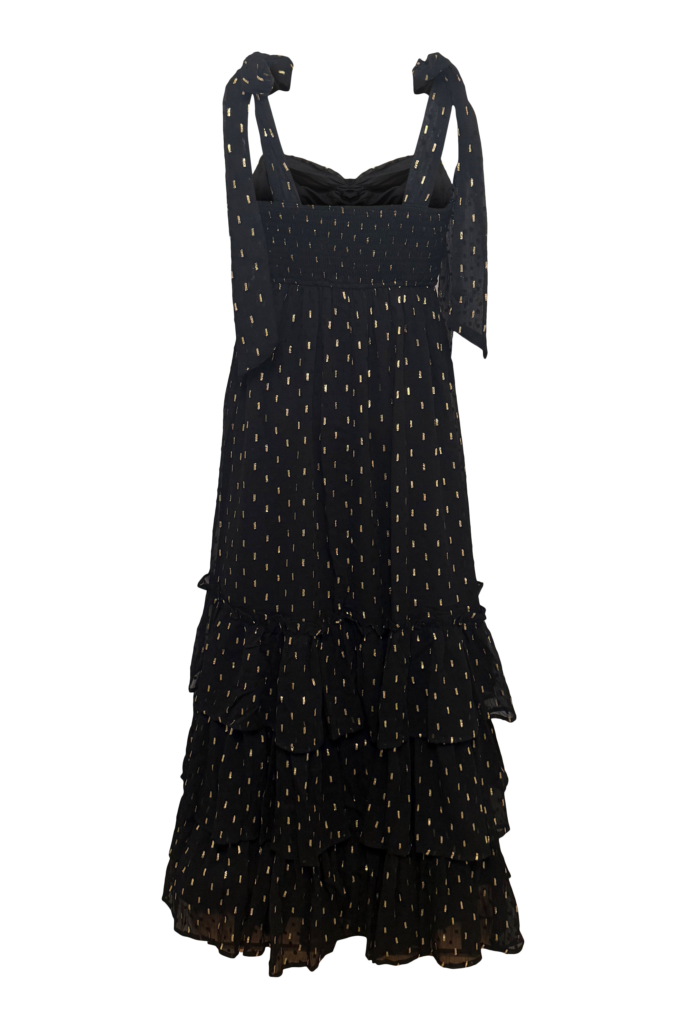 Black dress with gold polka dots on a white background