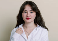 Model wearing silver hold your horses necklace standing against neutral background