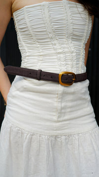 soft suede belt in rich brown tone featuring organic gold buckle on model